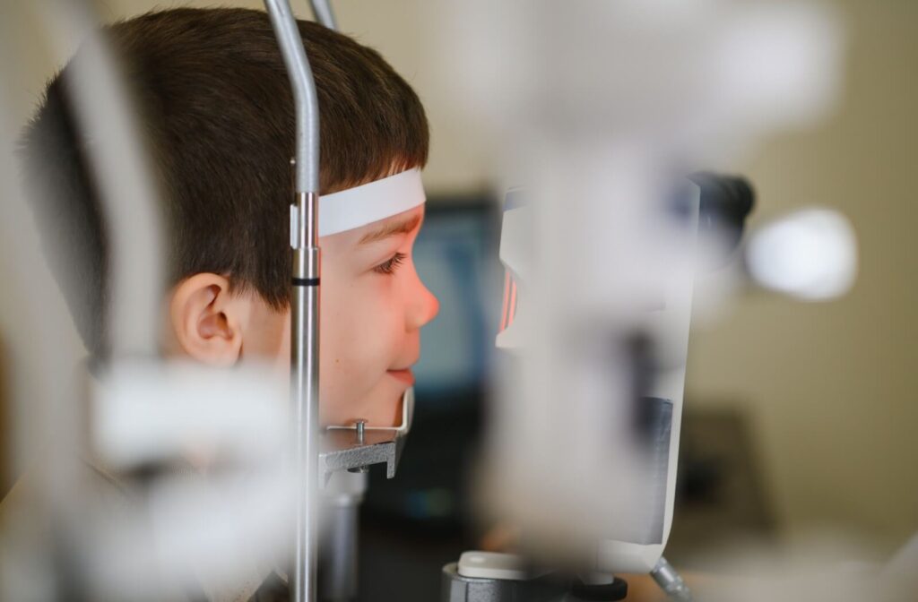 A child having an eye examination using optometry equipment.